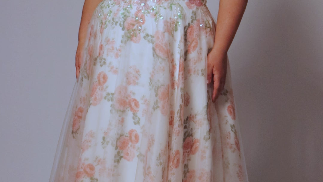 Tease Prom style TE2527 plus size floral prom dress. Printed floral organza with sequin floral leaf appliques.  Spaghetti straps with drape flutter sleeve. Exposed corset boning on bodice. A-line skirt with long invisible center back zipper. 