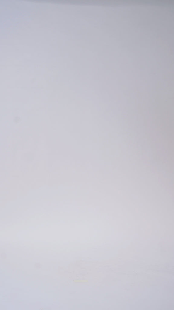 Woman models a white strapless lace mini dress with a sweetheart neckline and corset bodice, turning to show the back before walking off screen.