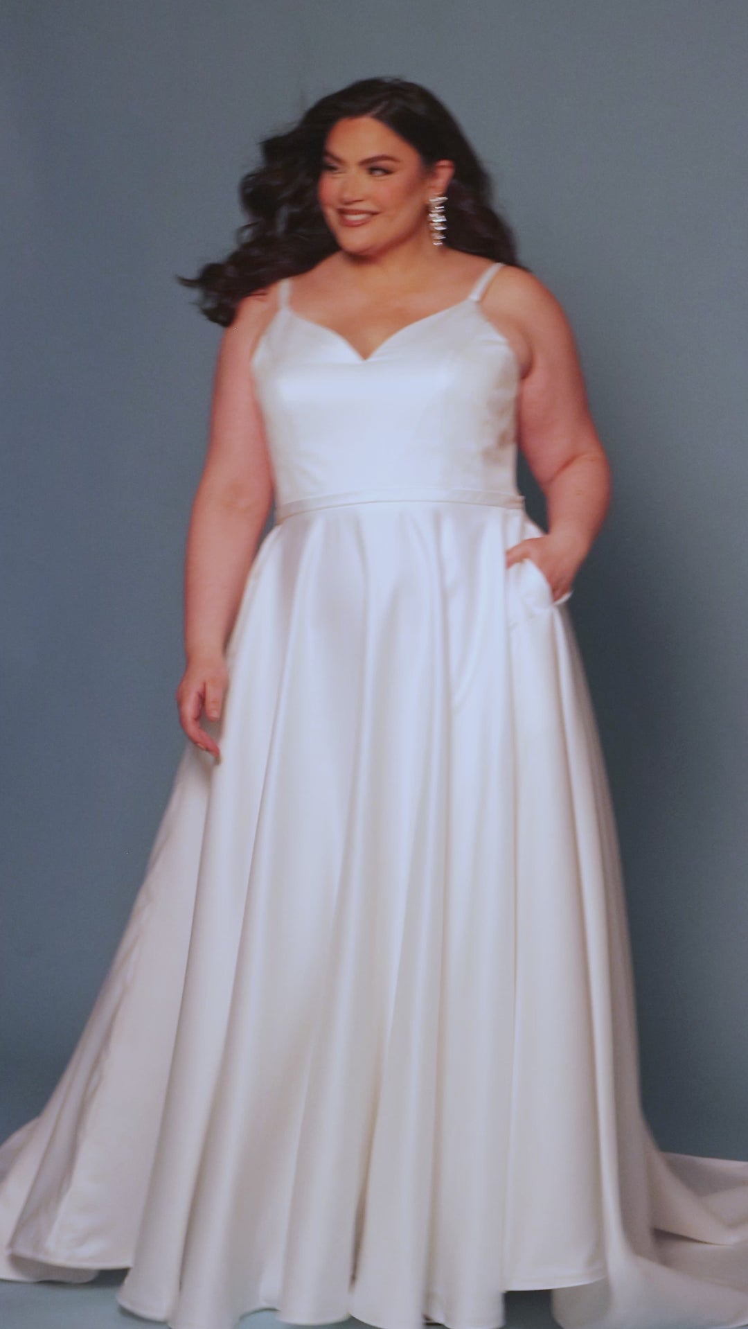 Sydney's Closet SC5313 Ivory. Bridal satin, Satin lining, Silhouette: A-line, Neckline: V-neckline, Double straps = ½ inch wide, Fully lined, Natural waistline, Long invisible center back zipper, Full A-line skirt, Optional ¾ inch belt, Pockets.