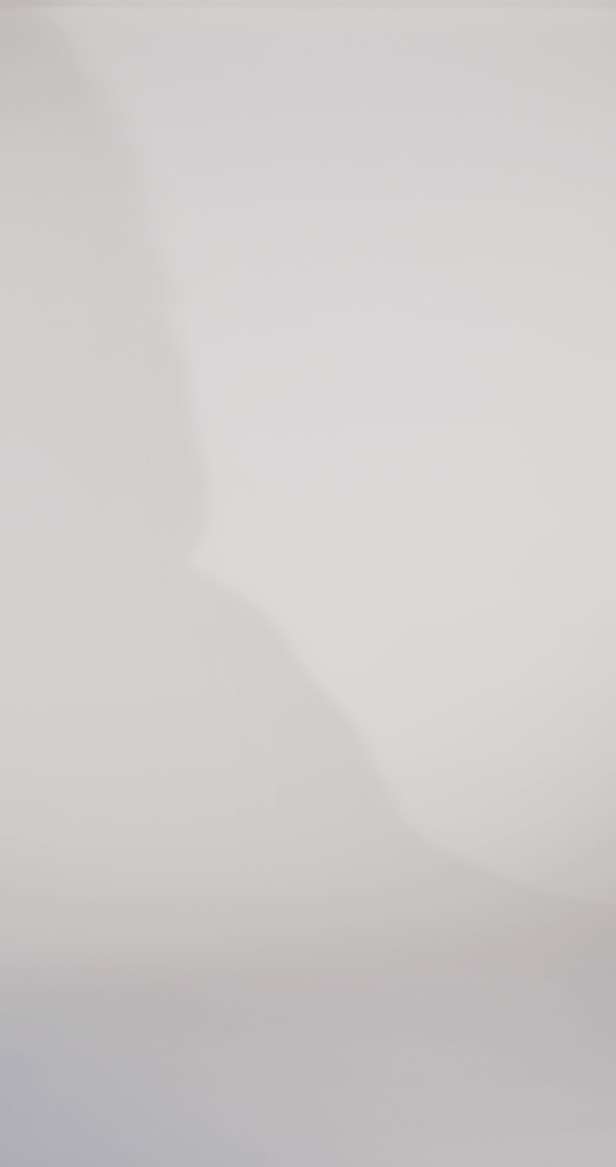 Woman models a strapless fitted blue dress with a ruched bust, rhinestones down the front, and a slit, showing the front and back before walking off screen.