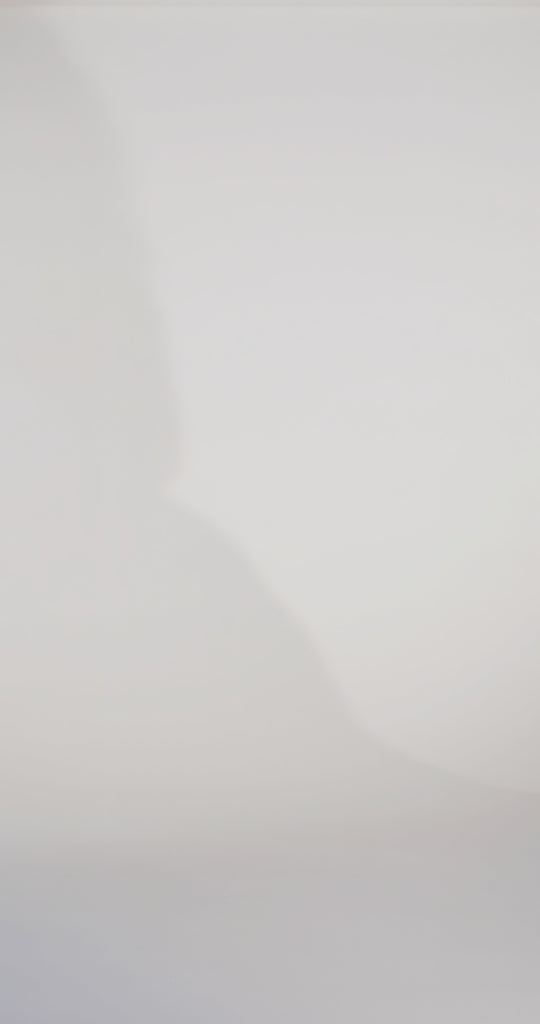 Woman models a strapless fitted blue dress with a ruched bust, rhinestones down the front, and a slit, showing the front and back before walking off screen.