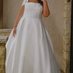 Video montage of a bride modeling a simple white A-line wedding gown with a square neckline and bra-friendly straps with bows, shown outdoors from multiple angles and distances. The text “Eloise” and the “Sydney's Closet” logo appear at the bottom.