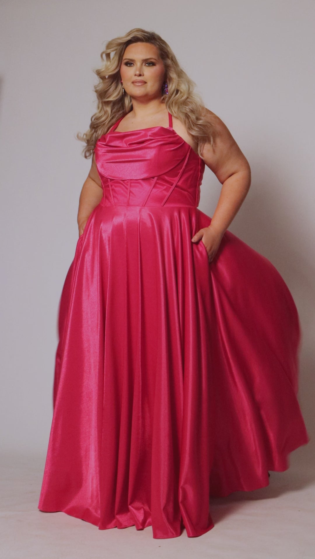 Tease Prom style TE2532 is available in black, blue, pink, purple or red in plus sizes 14-32.  Pleated draped bodice with exposed boning and optional bodice lining. Full A-line skirt with pockets. Straps go into lace up ties with modesty panel on the back. 