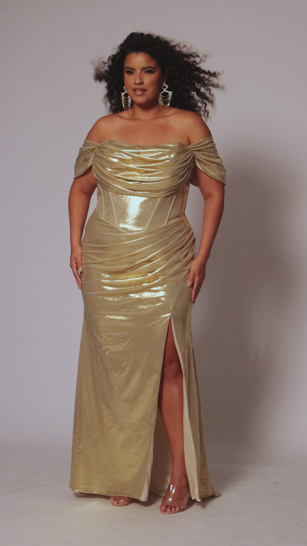 Plus size metallic fitted gold or teal prom dress.  Pleated dramaticbodice with detachable drape sleevesand exposed corset boning on basque waistline.  Slim, fitted skirt with ruching and high slit. Tease Prom style TE2515