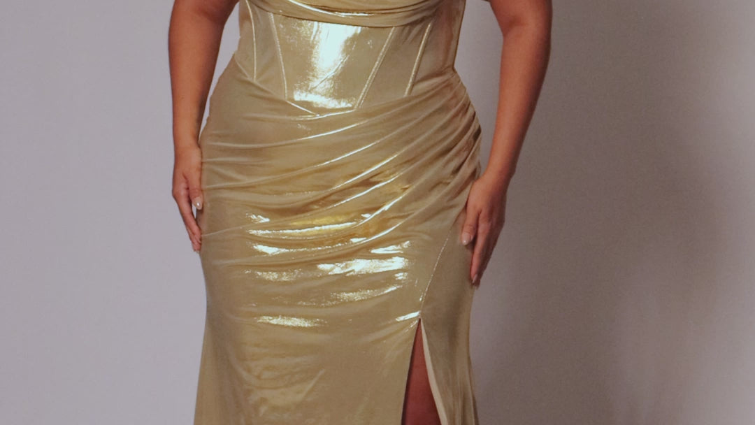 Plus size metallic fitted gold or teal prom dress.  Pleated dramaticbodice with detachable drape sleevesand exposed corset boning on basque waistline.  Slim, fitted skirt with ruching and high slit. Tease Prom style TE2515