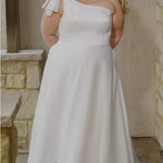 Video montage of a bride modeling a simple white one shoulder A-line wedding gown with a strap detail, shown outdoors from multiple angles and distances. The text “Harmony” and the “Sydney's Closet” logo appear at the bottom.