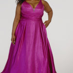 Sydney's Closet Style SC7453 in Magenta Pink

Plus Size A-line prom dress in metallic shimmer knit fabric, V-neckline with nude mesh insert, bra-friendly straps, pleated bodice, natural waisltine, A-line skirt with box pleats, pockets and a horsehair hem.
