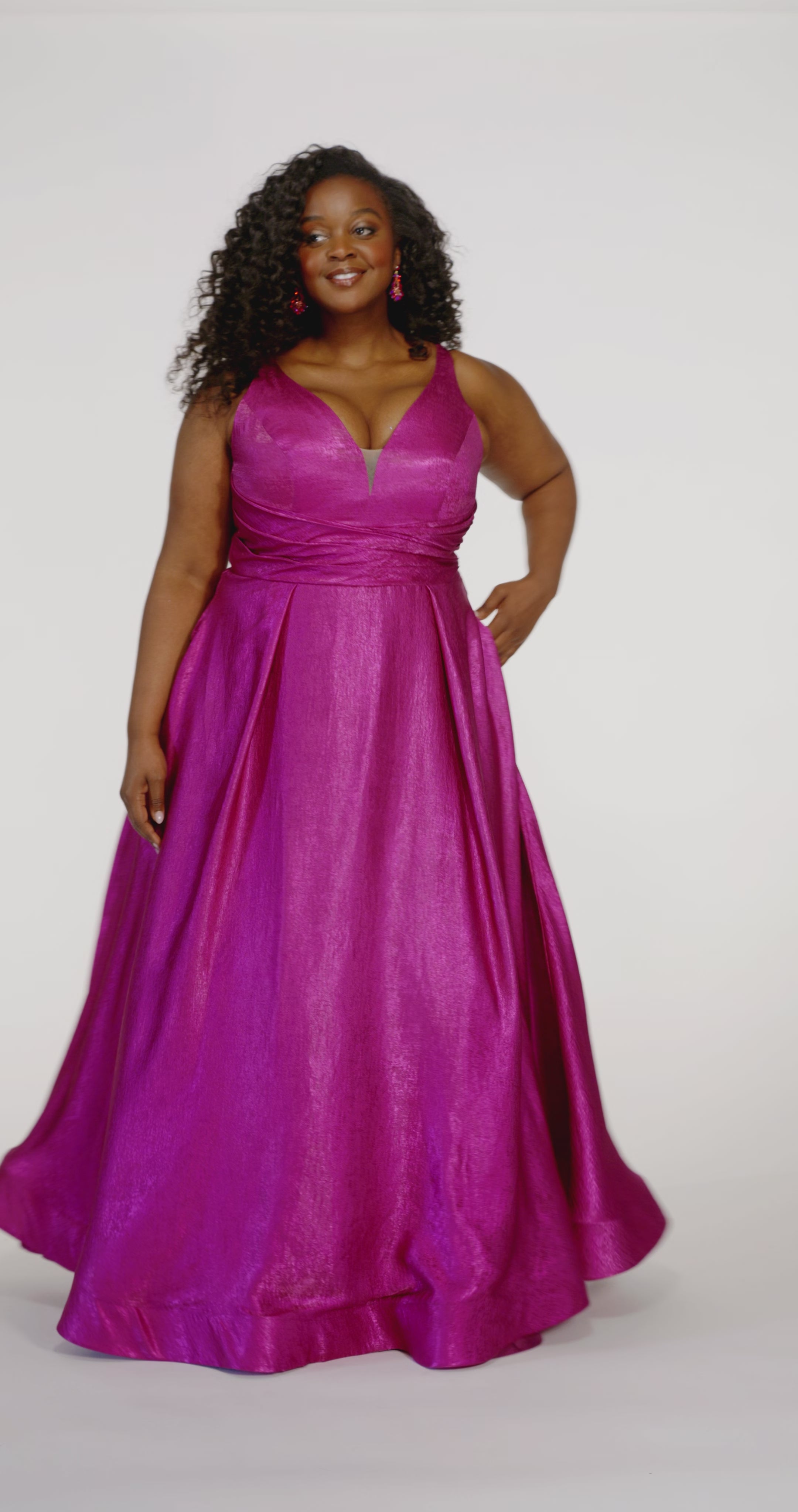 Sydney's Closet Style SC7453 in Magenta Pink

Plus Size A-line prom dress in metallic shimmer knit fabric, V-neckline with nude mesh insert, bra-friendly straps, pleated bodice, natural waisltine, A-line skirt with box pleats, pockets and a horsehair hem.