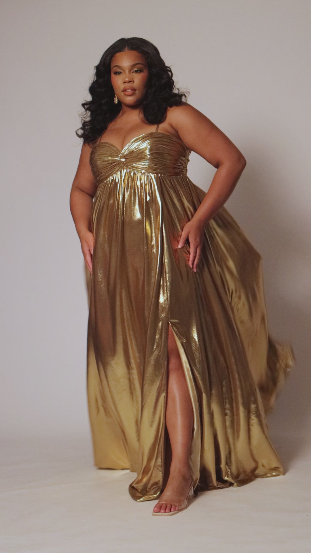 Empire plus size formal dress with spaghetti straps, pleated bodice with knot detail, pockets and slit. Available in gold, onyx black and ruby red. SC7414 by Sydney's Closet