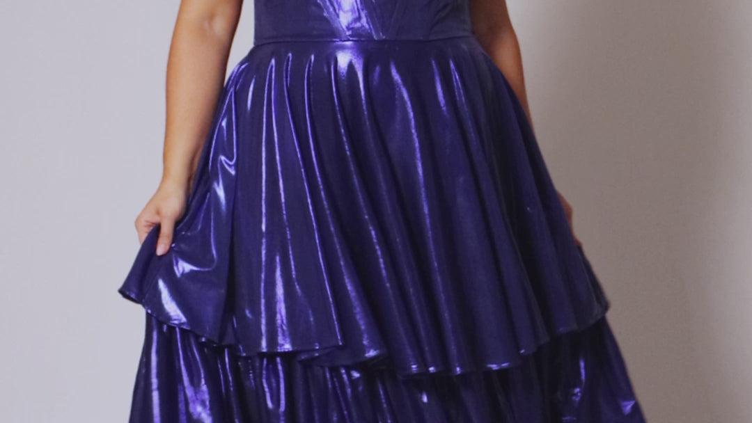 Plus size metallic tiered prom dress.  Strapless bodice with pleating and exposed boning. Detachable pleated drape sleeves. Available in fuchsia pink, indigo dark blue and onyx black. Style TE2510 by Tease Prom.