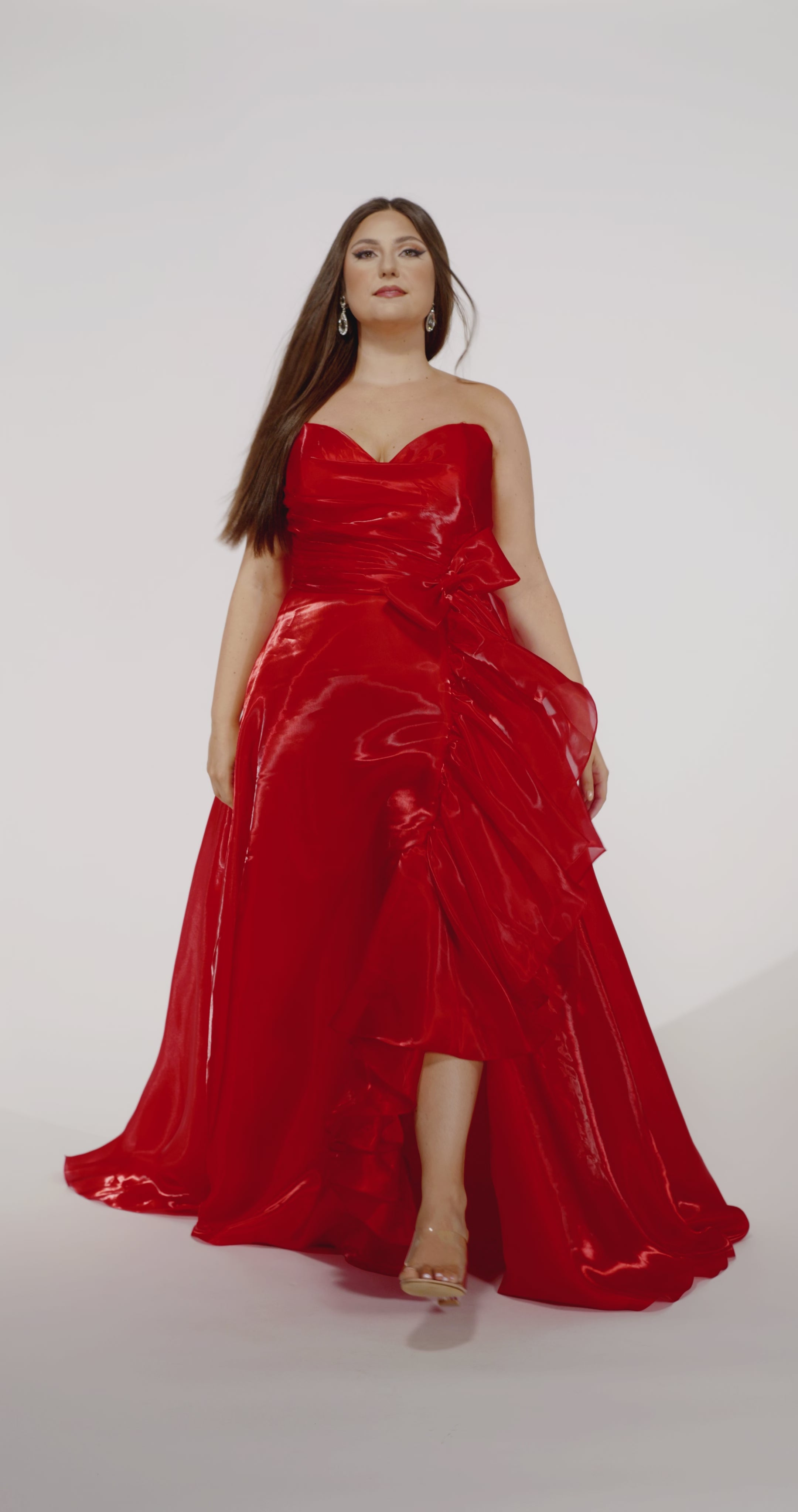 Johnathan Kayne for Sydney's Closet style JK2608.

Strapless sweetheart plus size A-line gown.  Ruched bodice with bow at natural waistline and flounce down left leg slit. Shiny organza fabric for lightweight comfort. Available in sizes  10-32 in Red, Black and Blue. 