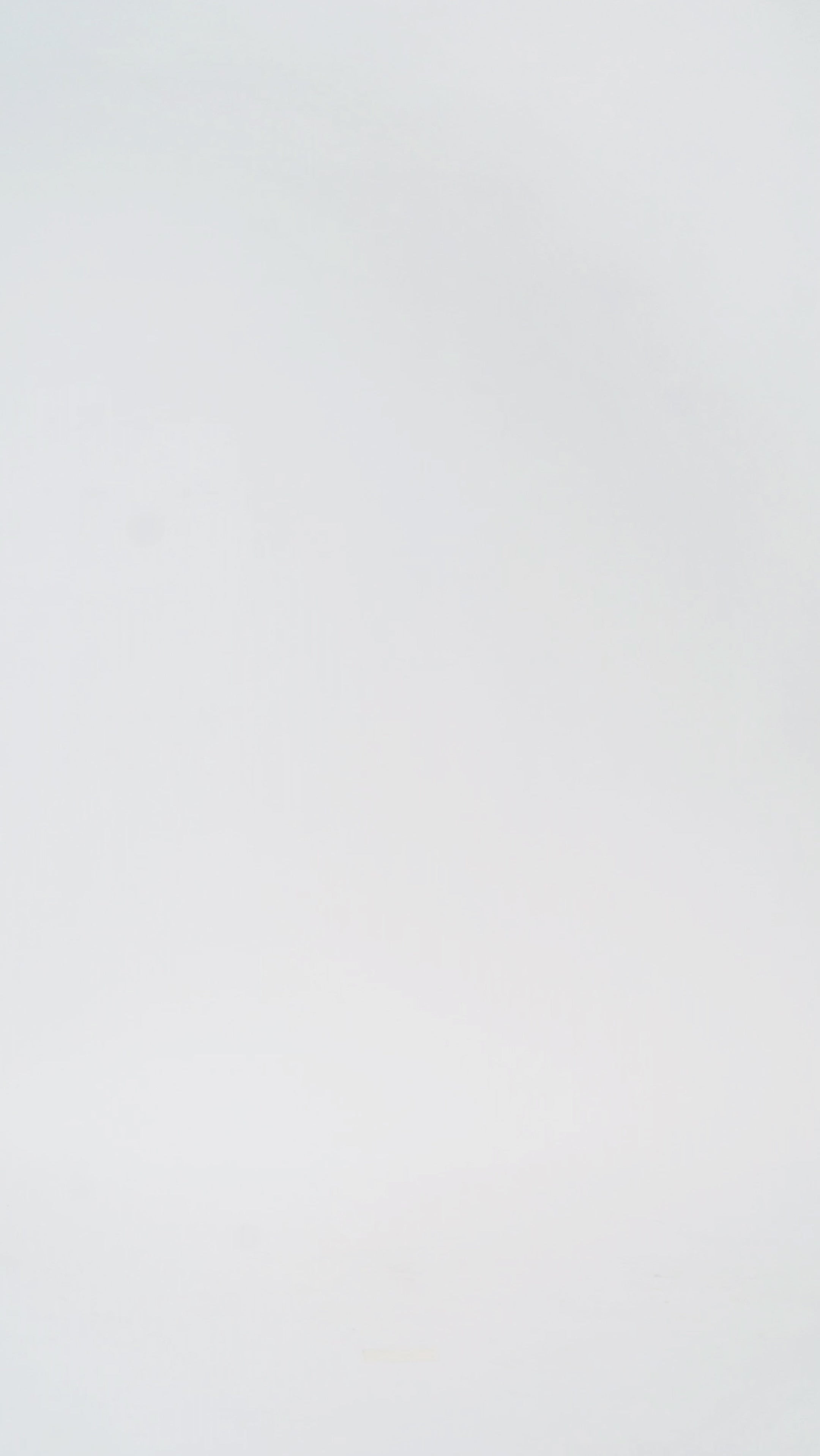 Woman models a strapless tea-length dress with a brown and black animal print and folded neckline detail, turning to show the back before walking off screen.