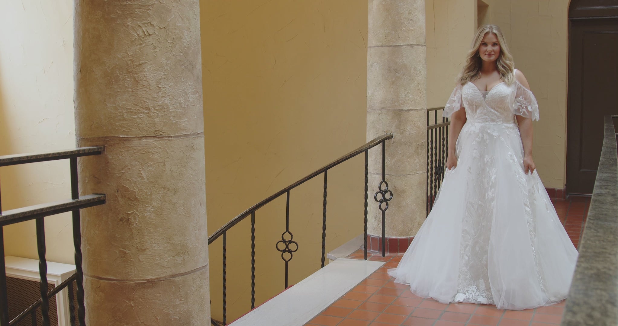 Michelle Bridal MB2408 Ivory. Bridal tulle and satin with leaf and floral appliques, Ballgown silhouette, V-neckline, Spaghetti straps covered in appliques, Drape sleeve, Invisible center back zipper with 24 covered buttons and elastic loops, Natural waistline, Scoop back