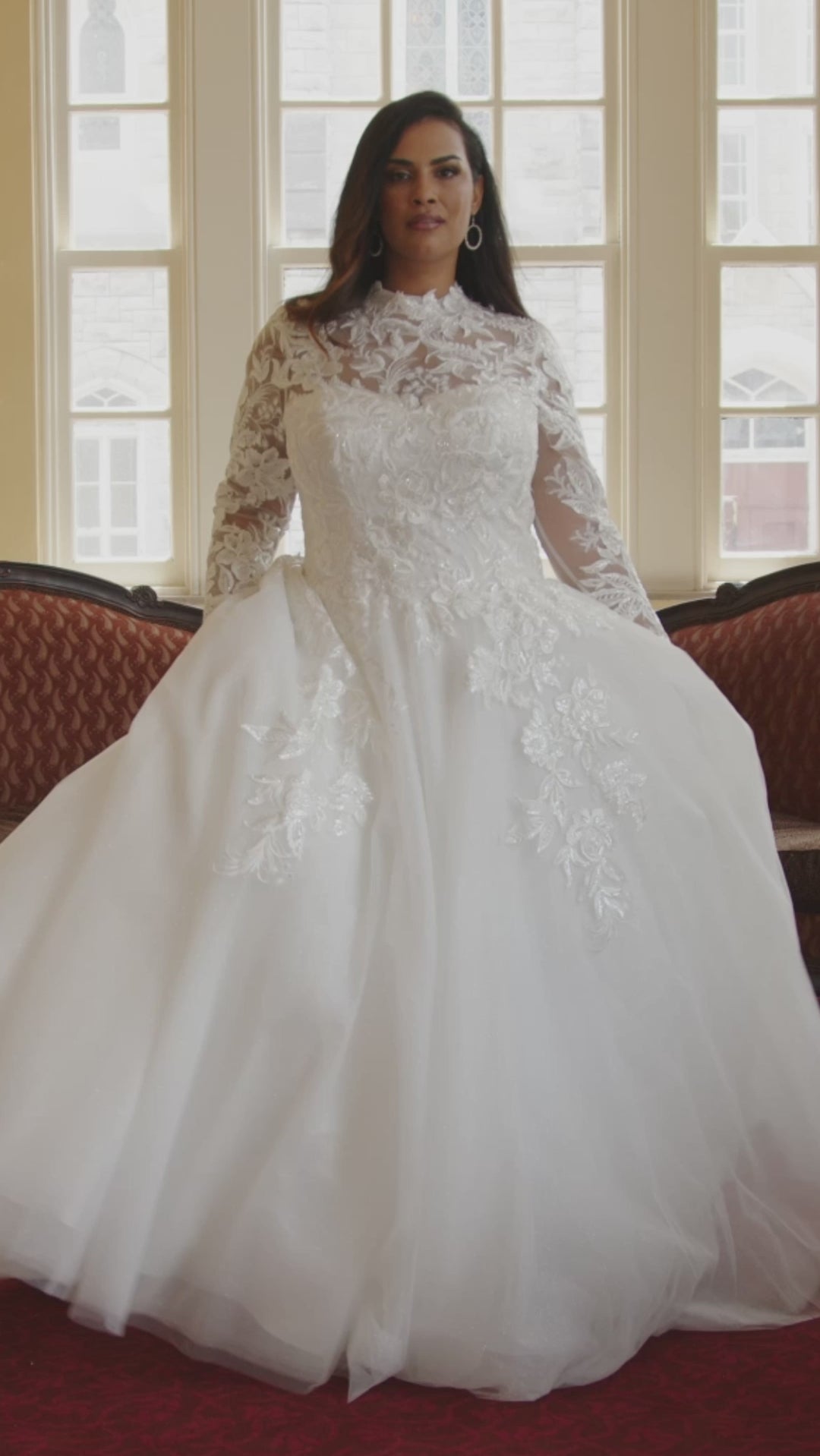 Michelle Bridal MB2424 Ivory. Embroidered lace appliques on mesh, Bridal tulle, sparkle tulle, Light lining, Leaf lace appliques, clear sequins, cut glass, Ballgown silhouette, High Neckline, Collar = 1 inch beaded appliques, Illusion bodice covered in beaded appliques, Sweetheart lining, Long sleeves covered in appliques with sequins, Closure at wrist = covered buttons with elastic loops, V-back, Invisible center back zipper.