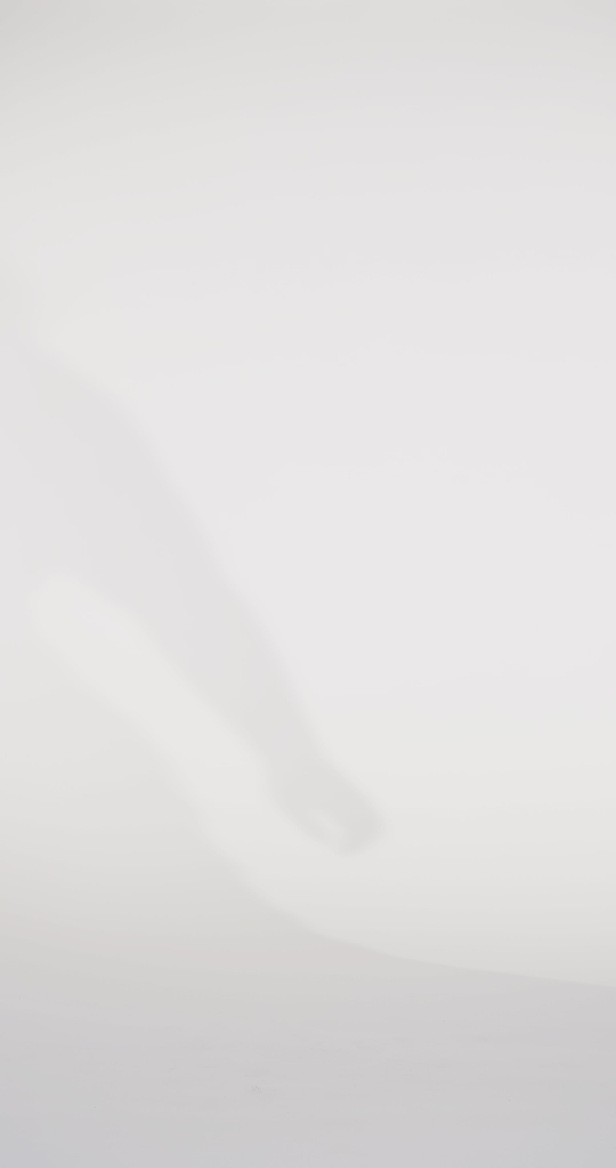 Woman models a black off-the-shoulder slim dress with a high slit, draped panel, and lace and sparkle detailing on the bodice, waving the drape panel and turning to show the lace-up back before walking off screen.