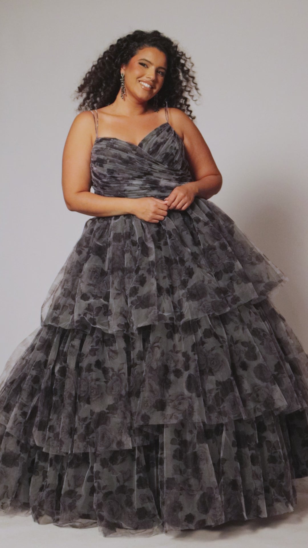 Best selling plus size floral tiered ballgown dress style TE2525 by Tease Prom.  Double spaghetti straps on pleated V-neckline bodice with tiered ball gown skirt in floral print tulle. Available in black floral or blue floral in sizes 14-32. 