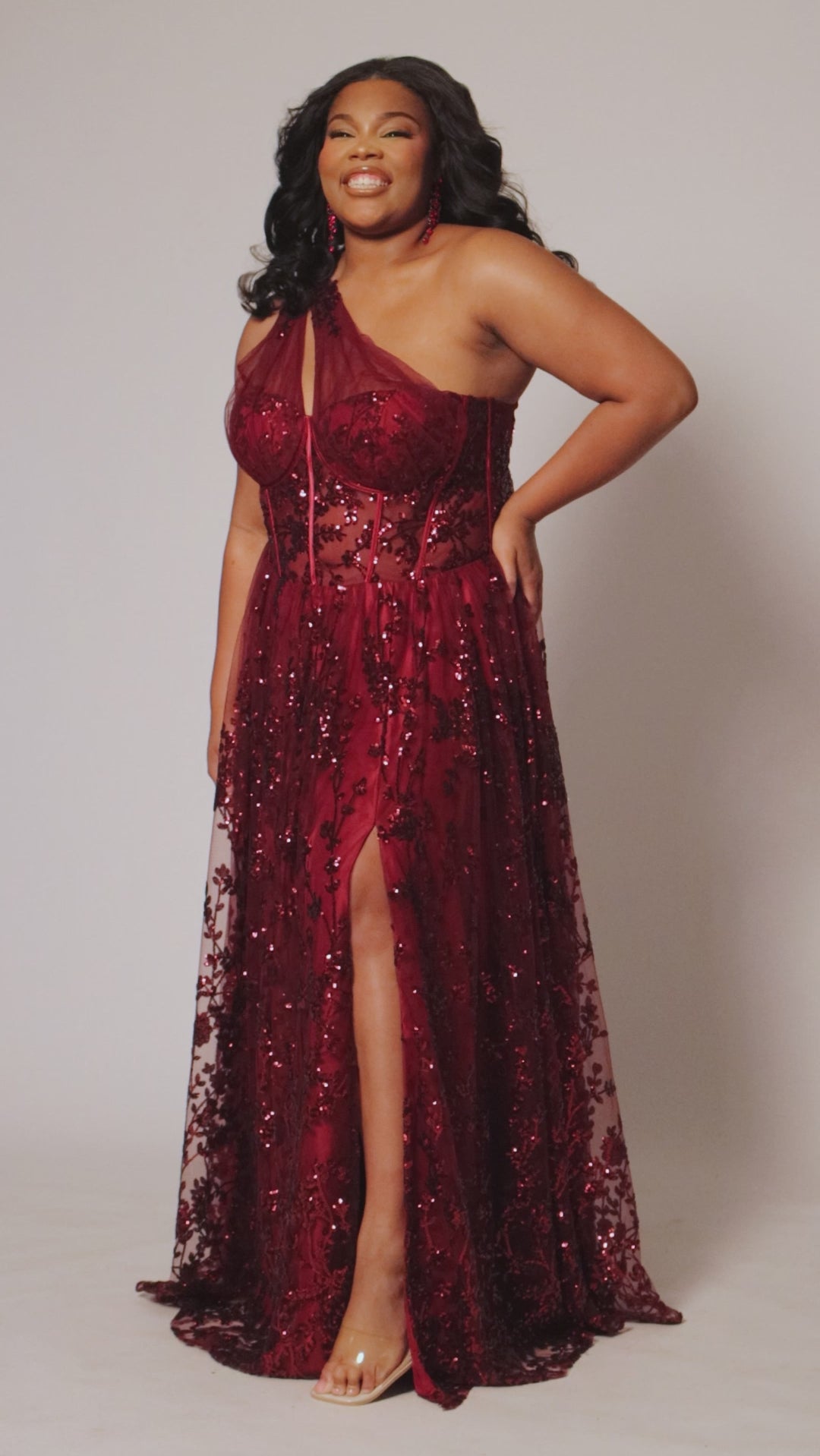 Plus size prom ball gown with glitter lace and tulle. Style TE2529 by Tease Prom is avialable in burgundy red, forest green or onyx black in sizes 14-32.  One shoulder with illusion cut out on sweetheart bodice with exposerd corset boning. 