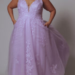 Plus size lace and tulle ball gown by Tease Prom.  Style TE2526 available in lilac purple or sage green.  Deep v-neckline with nude mesh insert. Wide straps and bodice fully covered with appliques.  Bodice is unlined but ships with optional lining panel.  Full A-line skirt with scattered lace appliques, pockets and sweep train. 