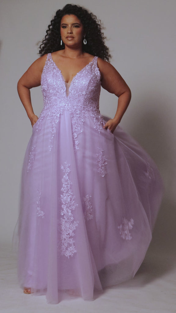 Plus size lace and tulle ball gown by Tease Prom.  Style TE2526 available in lilac purple or sage green.  Deep v-neckline with nude mesh insert. Wide straps and bodice fully covered with appliques.  Bodice is unlined but ships with optional lining panel.  Full A-line skirt with scattered lace appliques, pockets and sweep train. 