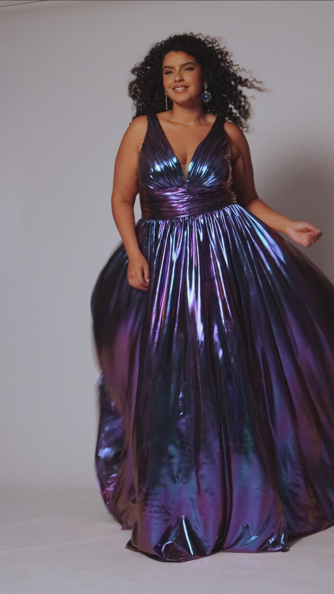 Best selling plus size A-line prom, formal and evening dress. Metallic stretch knit novelty fabric, bra-friendly straps, full A-line skirt and pockets. Available in peacock (blue/green) and Prism (blue/purple) sizes 14-40. SC7415 by Sydney's Closet