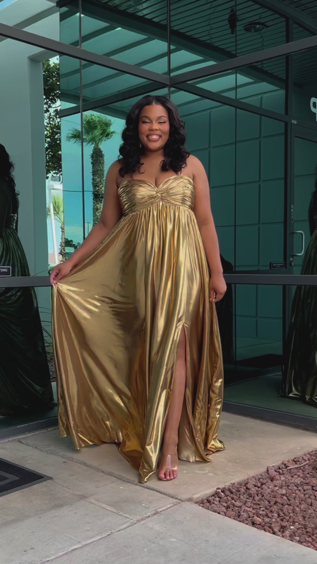 Empire plus size formal dress with spaghetti straps, pleated bodice with knot detail, pockets and slit. Available in gold, onyx black and ruby red. SC7414 by Sydney's Closet