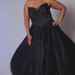 Long formal satin ballgown style SC7400 by Sydney's Closet. Available in sizes 14-32 in colors cobalt blue, onyx black and ruby red.  Pleated bodice with exposed boning, detachable pleated drape sleeves, basque waist and pockets.  