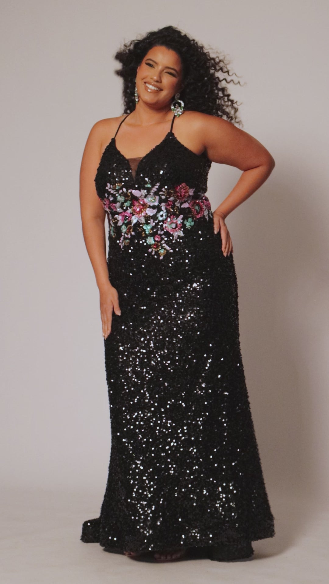 Tease Prom style TE2524 available in black with ivory floral sequin motif.  Spaghetti straps into a razor back with keyhole cutout. Deep V-neckline with black mesh. Slim fitted skirt with sweep train and horsehair hem. 