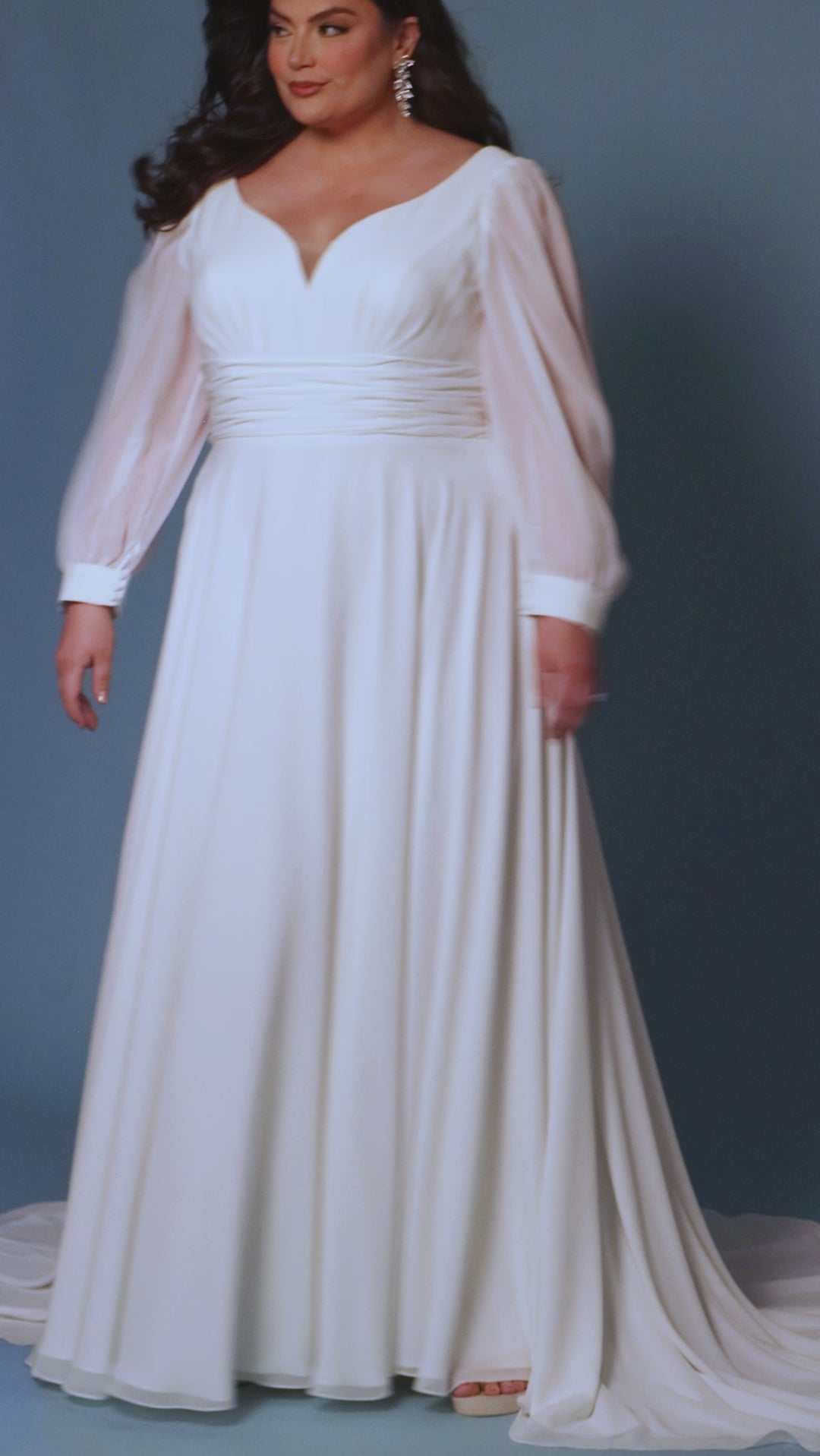 Sydney's Closet SC5320 ivory. Bridal chiffon, Satin lining, Silhouette: A-line, Neckline: V-neckline, Lightly pleated bodice, Bra-friendly straps, Long sleeves with cuff, Fully lined, Natural waistline, V-back, Long invisible center back zipper.