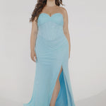 Woman models a strapless fitted seafoam dress with a ruched bust, rhinestones down the front, and a slit, showing the front while standing in frame.