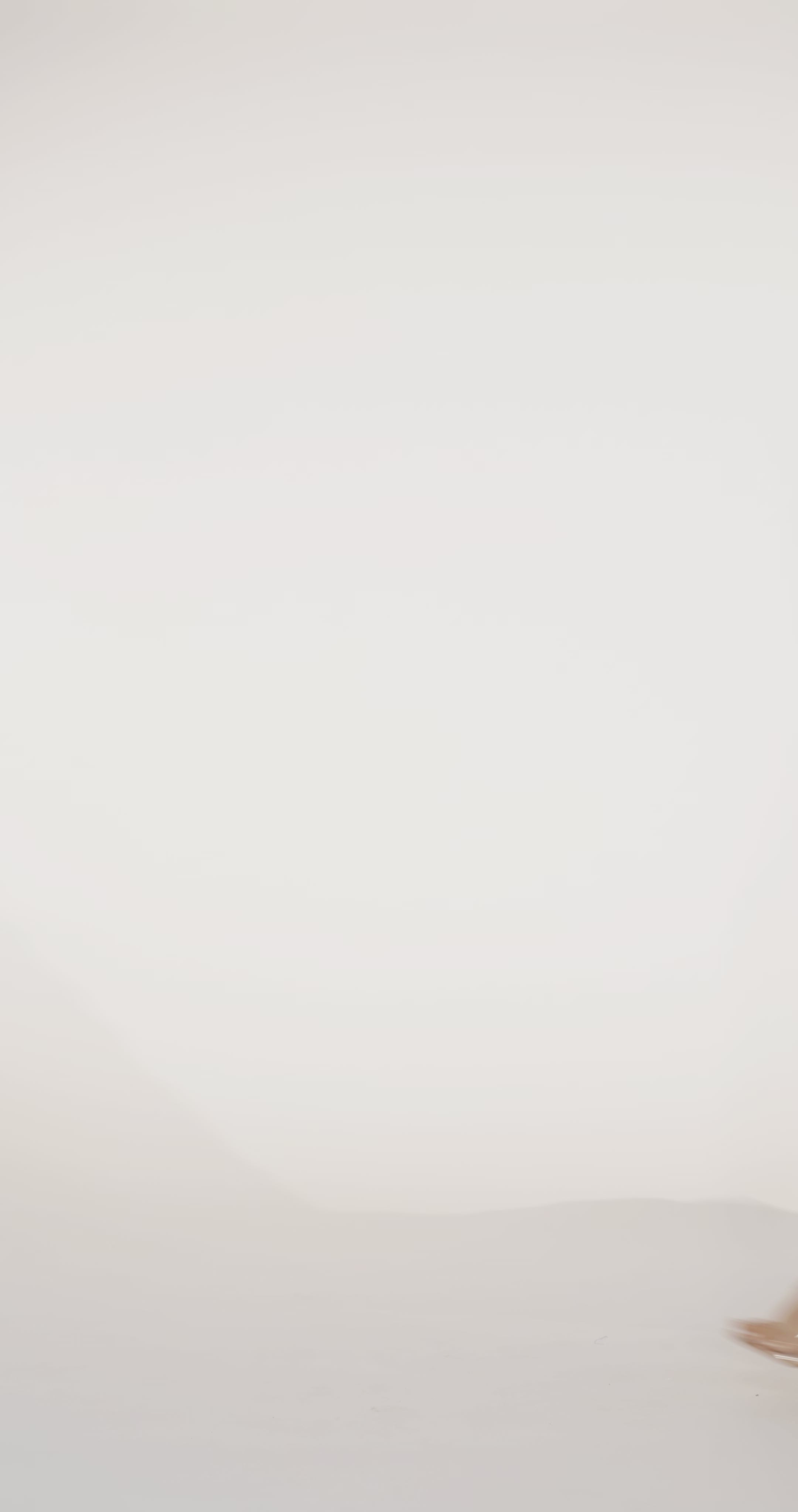 Woman models a red off-the-shoulder slim dress with a high slit, draped panel, and lace and sparkle detailing on the bodice, waving the drape panel and turning to show the lace-up back before walking off screen.