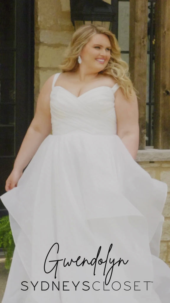 Video montage of a bride modeling a tiered white A-line wedding gown with a criss cross ruched bodice, shown outdoors from multiple angles and distances. The text “Gwendolyn” and the “Sydney's Closet” logo appear at the bottom.