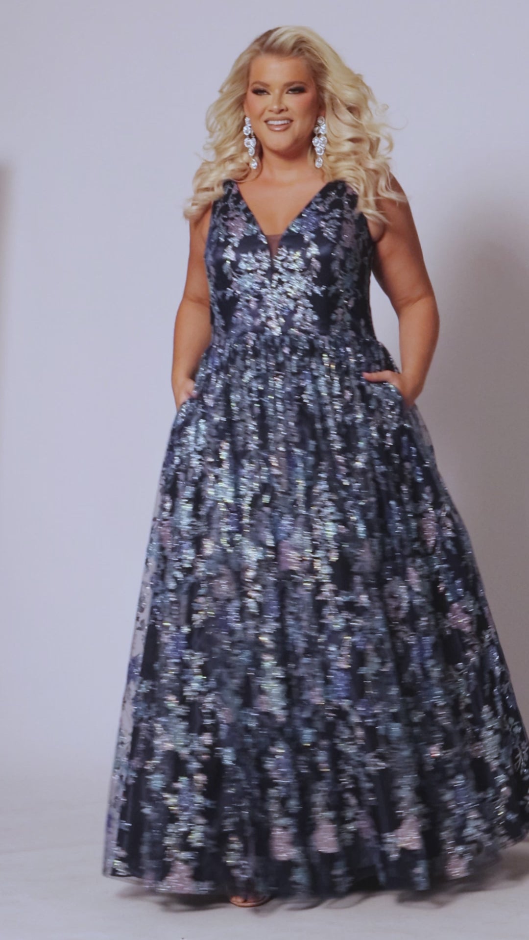 Tease Prom style TE2501 in midnight blue. Plus size A-line sequin glitter on net prom dress. Bra-friendly straps, emsh insert, pockets and full A-line skirt with crinoline. 
