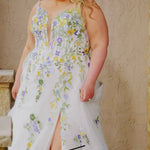Video montage of a bride modeling a floral A-line wedding gown with a deep v-neckline, shown outdoors from multiple angles and distances. The text “Tullia” and the “Sydney's Closet” logo appear at the bottom.