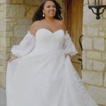 Michelle Bridal MB2618 

Strapless sweetheart ballgown. Soft bridal tulle, floral lace appliques, lightweight satin lining. Natural waistline, A-Line skirt. Bicep optional puff sleeves. Straight across back, center back zipper, train and covered buttons. 