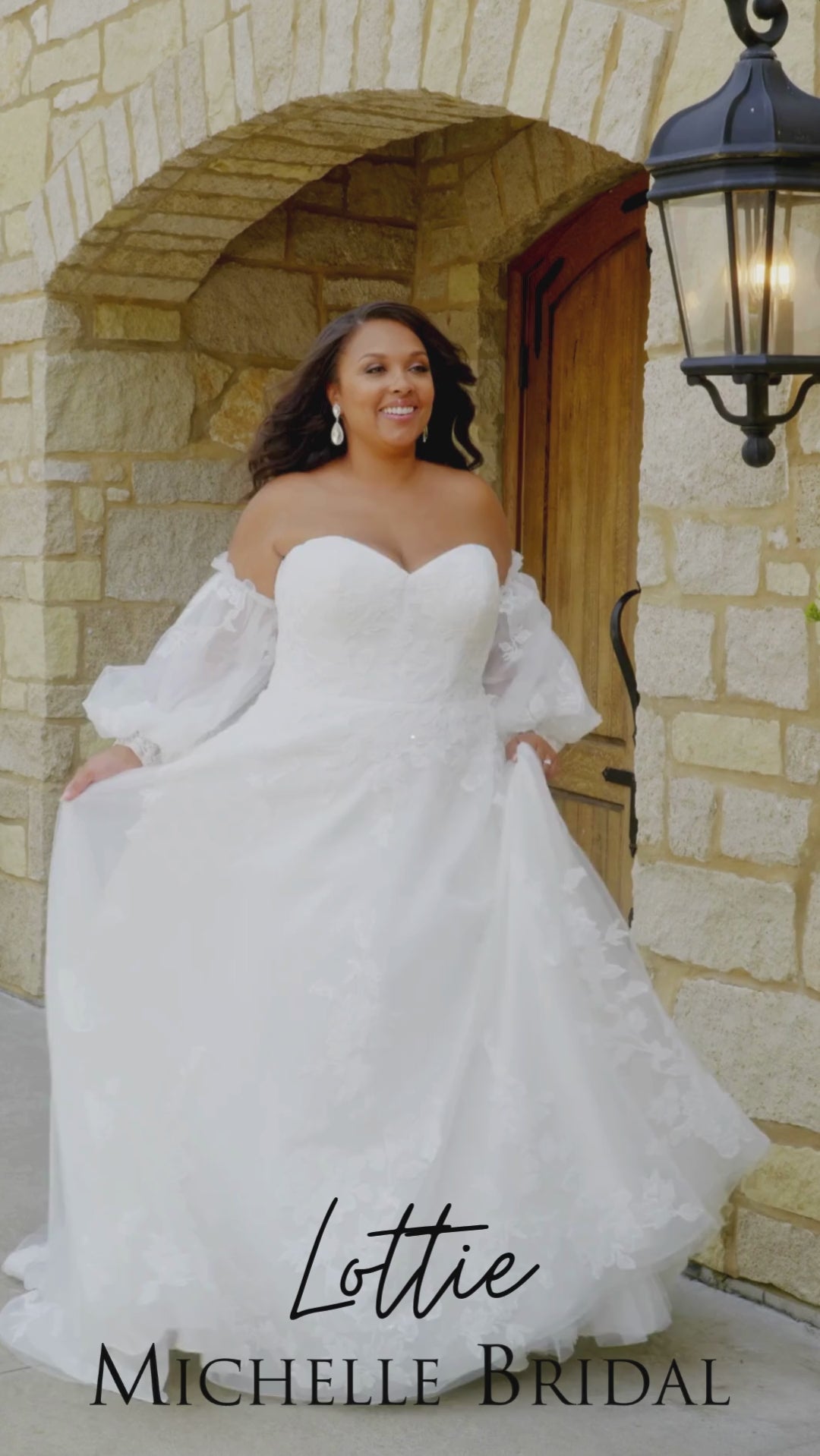 Michelle Bridal MB2618 

Strapless sweetheart ballgown. Soft bridal tulle, floral lace appliques, lightweight satin lining. Natural waistline, A-Line skirt. Bicep optional puff sleeves. Straight across back, center back zipper, train and covered buttons. 