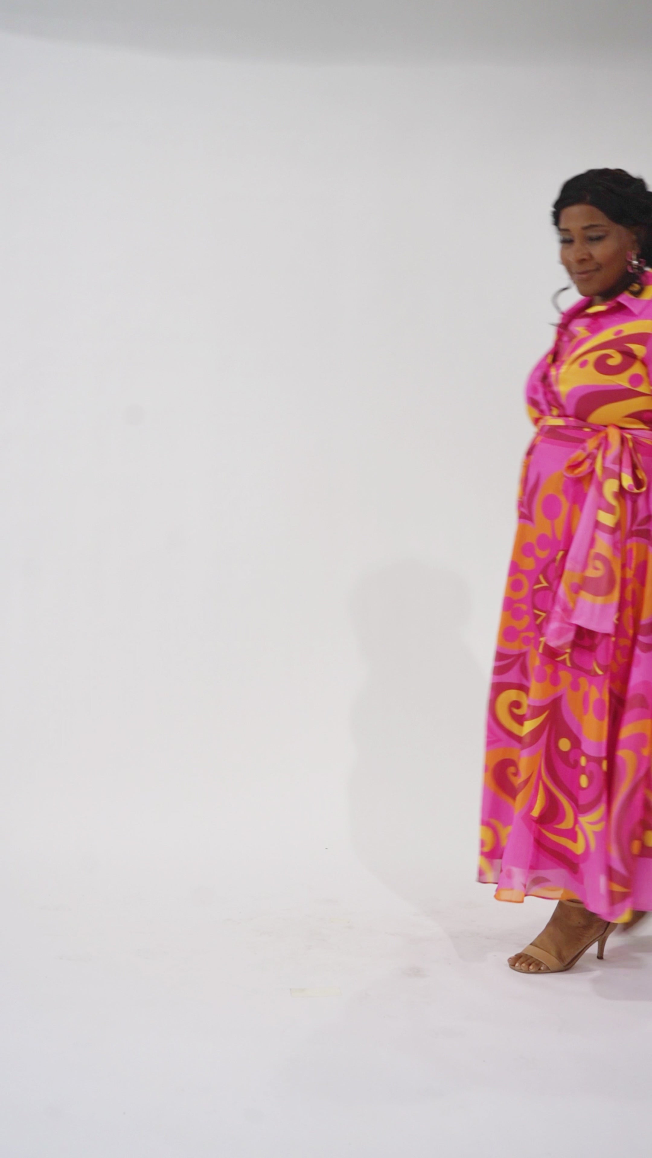 Celebration's by Sydney's Closet style CE2622 in abstract print. 

Button down plus size ankle length gown made from printed organza. V-neck, long pouf sleeves with cuff and optional belt. A-line skirt with pockets.