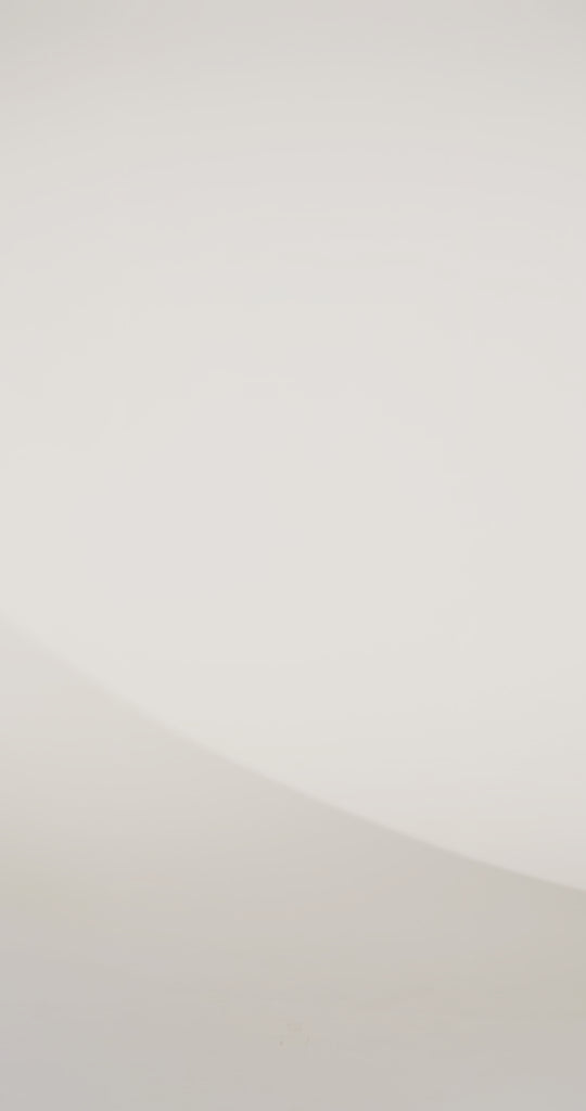 Woman models an off-the-shoulder A-line gown with a blue floral pattern and high slit, spinning to show the skirt before walking off screen.