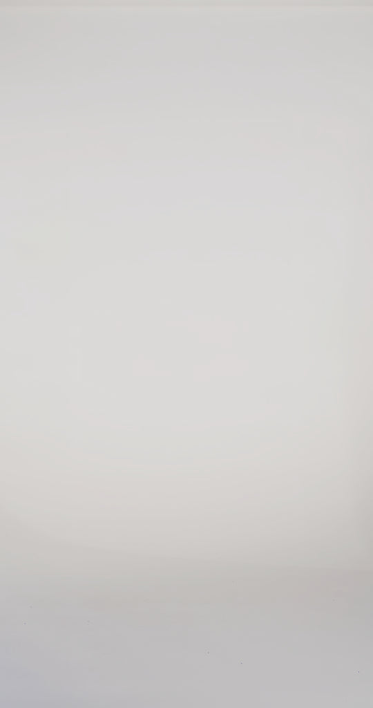 Woman models a teal strapless slim dress with a slit, exposed corset boning, a pleated band over the bust, and a sweep train, turning to show the lace-up back before walking off screen.