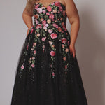 Plus Size Black Floral ballgown. Strapless, sweetheart neckline, full A-line skirt and center back zipper.  Pink, Purple, Red and Green embroidered floral lace appliques over  black sparkle tulle. Style SC7407 by Sydney's Closet.