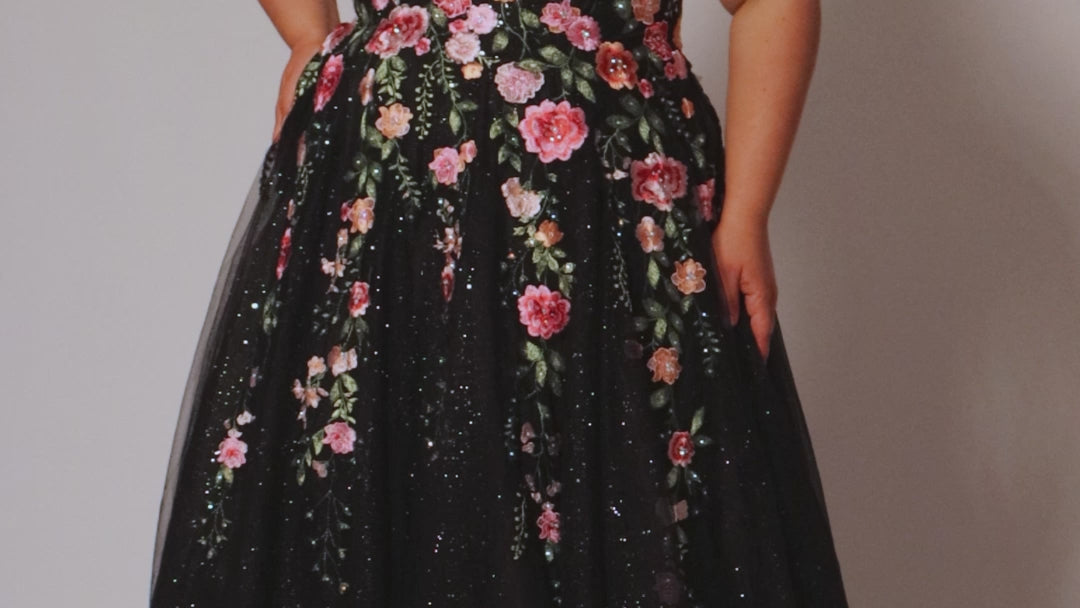 Plus Size Black Floral ballgown. Strapless, sweetheart neckline, full A-line skirt and center back zipper.  Pink, Purple, Red and Green embroidered floral lace appliques over  black sparkle tulle. Style SC7407 by Sydney's Closet.