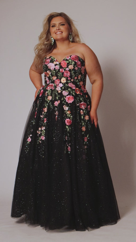 Plus Size Black Floral ballgown. Strapless, sweetheart neckline, full A-line skirt and center back zipper.  Pink, Purple, Red and Green embroidered floral lace appliques over  black sparkle tulle. Style SC7407 by Sydney's Closet.