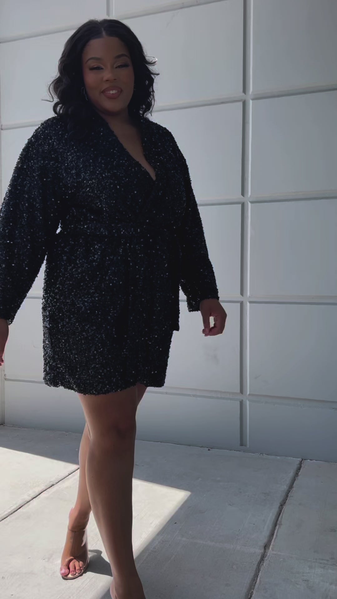 Our plus size sequin robe is a stunning, comfortable piece designed for confident, curvy women looking for comfort as they get ready on their special day. Made from stretch sequin with a light stretch knit lining, this robe is the perfect getting ready outfit  Roomy sleeves and an adjustable tie belt make for the perfect fit and pockets to hold your essentials! Style SC1009 by Sydney's Closet - Onyx Black Video outside of studio
