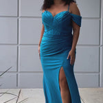 Sydney's Closet SC7402 sexy fitted prom dress in sparkle lycra .  Exposed boning on corset, drape sleeves with adjsutable spaghetti straps, high slit and ruchsed skirt. Available in violet purple, magenta pink, or turq blue and green. 