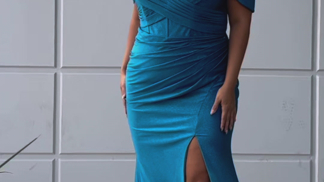 Sydney's Closet SC7402 sexy fitted prom dress in sparkle lycra .  Exposed boning on corset, drape sleeves with adjsutable spaghetti straps, high slit and ruchsed skirt. Available in violet purple, magenta pink, or turq blue and green. 
