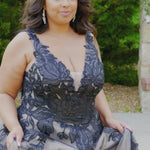 Plus size A-line oversized floral weding dress in black, ivory or champagne. Style MB2525 from Michelle Bridal by Sydney's Closet has illusions straps covered in appliques, natural waisltine, long flowy A-line skirt and long train with covered buttons. 