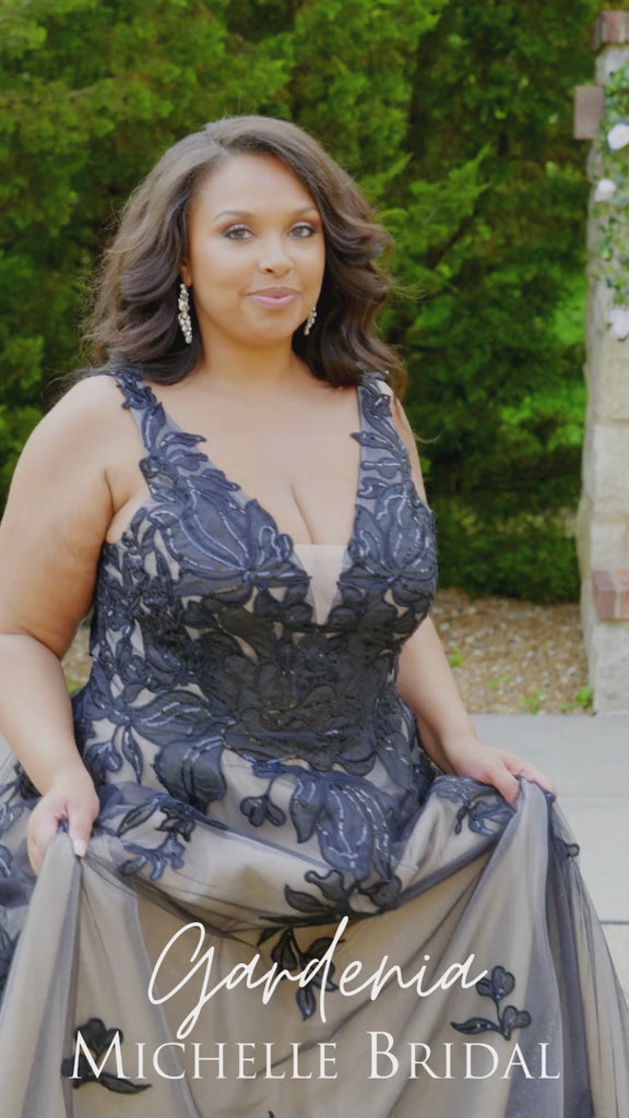 Plus size A-line oversized floral weding dress in black, ivory or champagne. Style MB2525 from Michelle Bridal by Sydney's Closet has illusions straps covered in appliques, natural waisltine, long flowy A-line skirt and long train with covered buttons. 