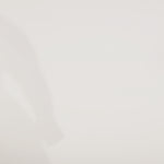 Woman models a slim black dress with a slit, exposed corset boning, a pleated band over the bust, and rhinestones along the neckline, showing the front and back before walking off screen.