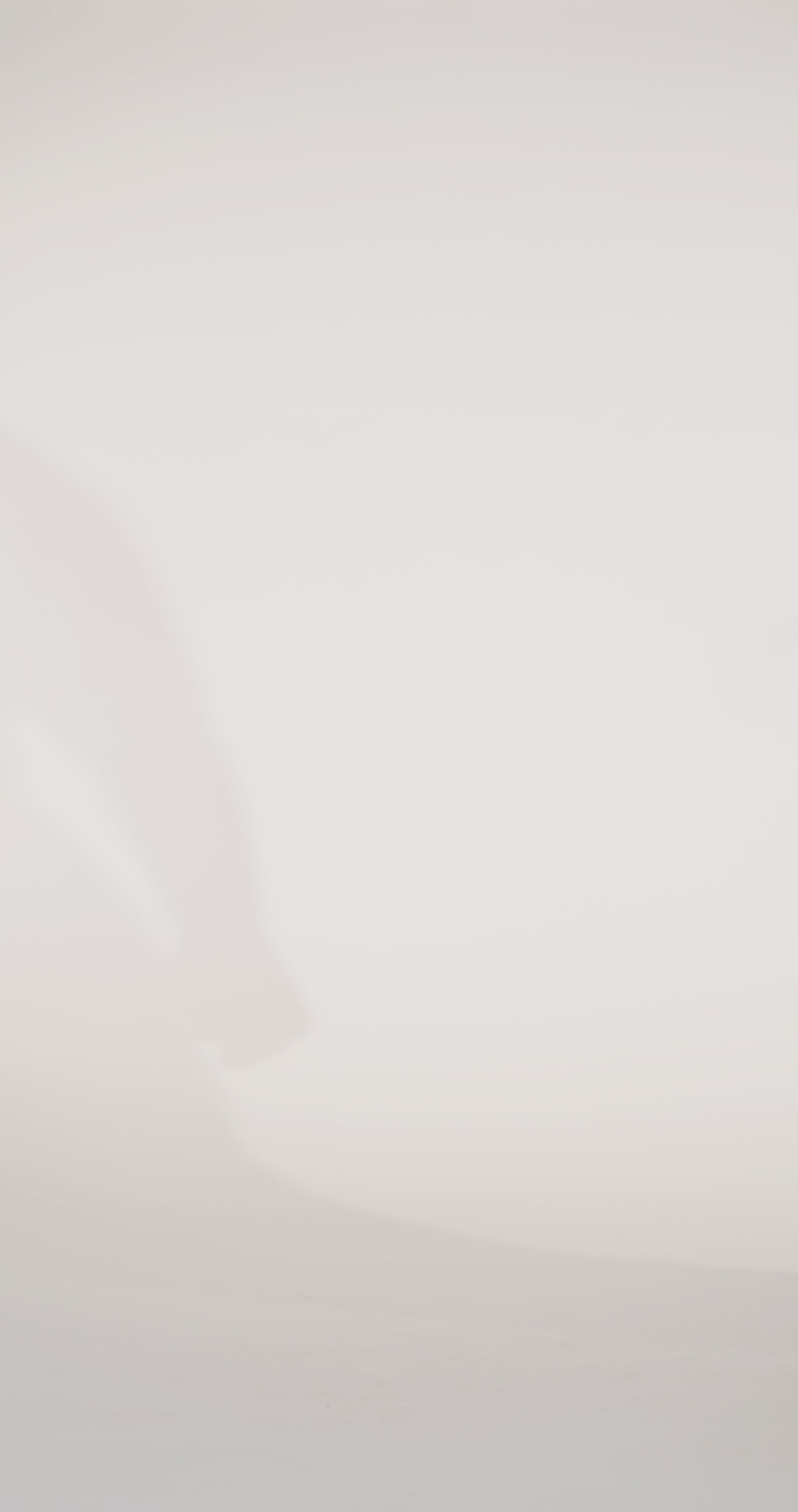 Woman models a slim black dress with a slit, exposed corset boning, a pleated band over the bust, and rhinestones along the neckline, showing the front and back before walking off screen.