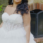 Video of a plus-size bride modeling the MB2608 wedding gown by Michelle Bridal, highlighting the structured bodice, flattering silhouette, and elegant movement of the skirt.