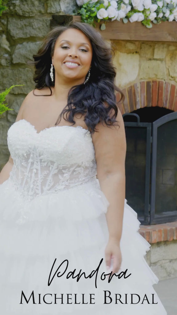Video of a plus-size bride modeling the MB2608 wedding gown by Michelle Bridal, highlighting the structured bodice, flattering silhouette, and elegant movement of the skirt.